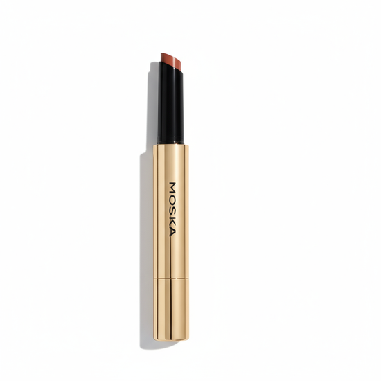 Lipstick with gold casing and black cap on a white background